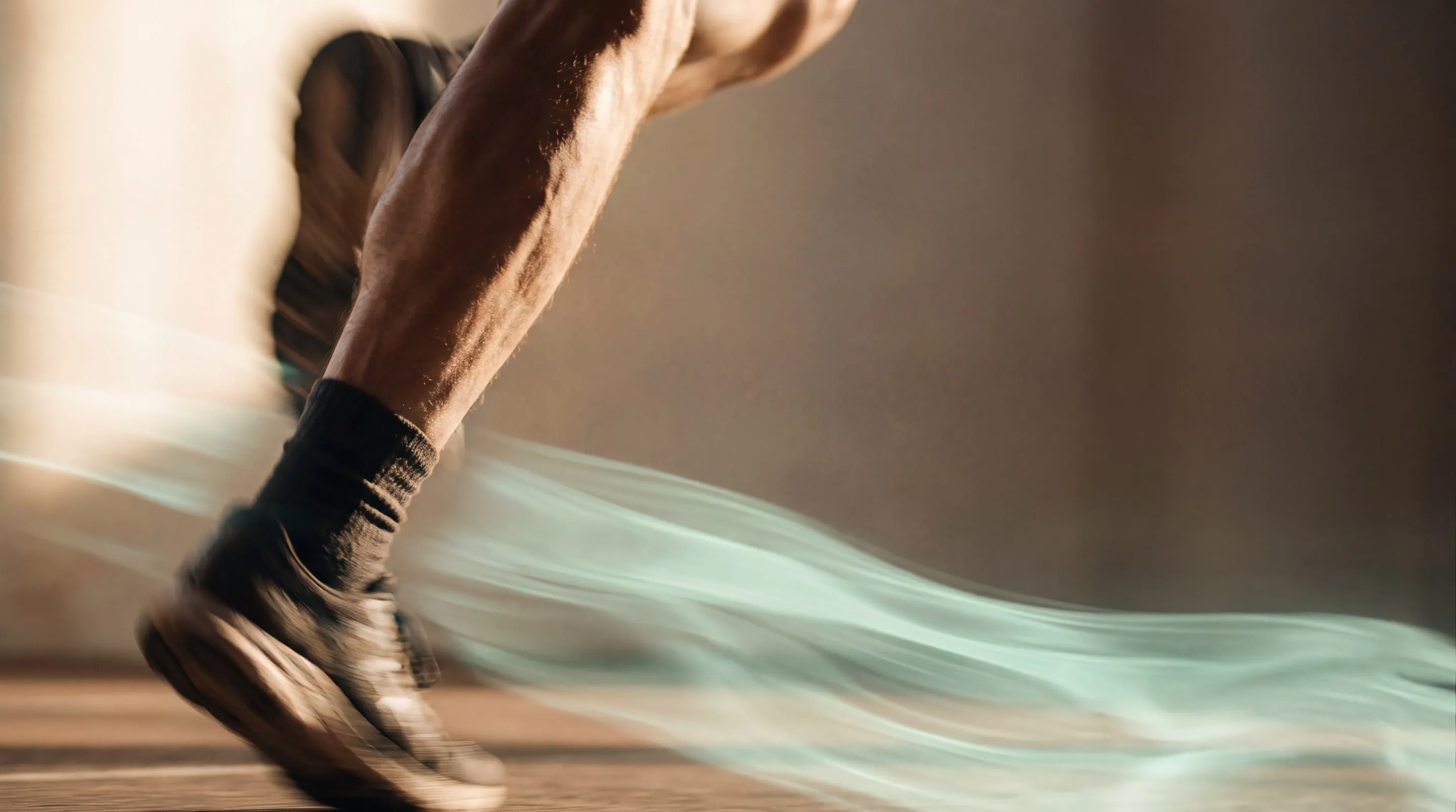 Close-up of a runner's leg mid-stride, a mint light trail streaking behind the shoe