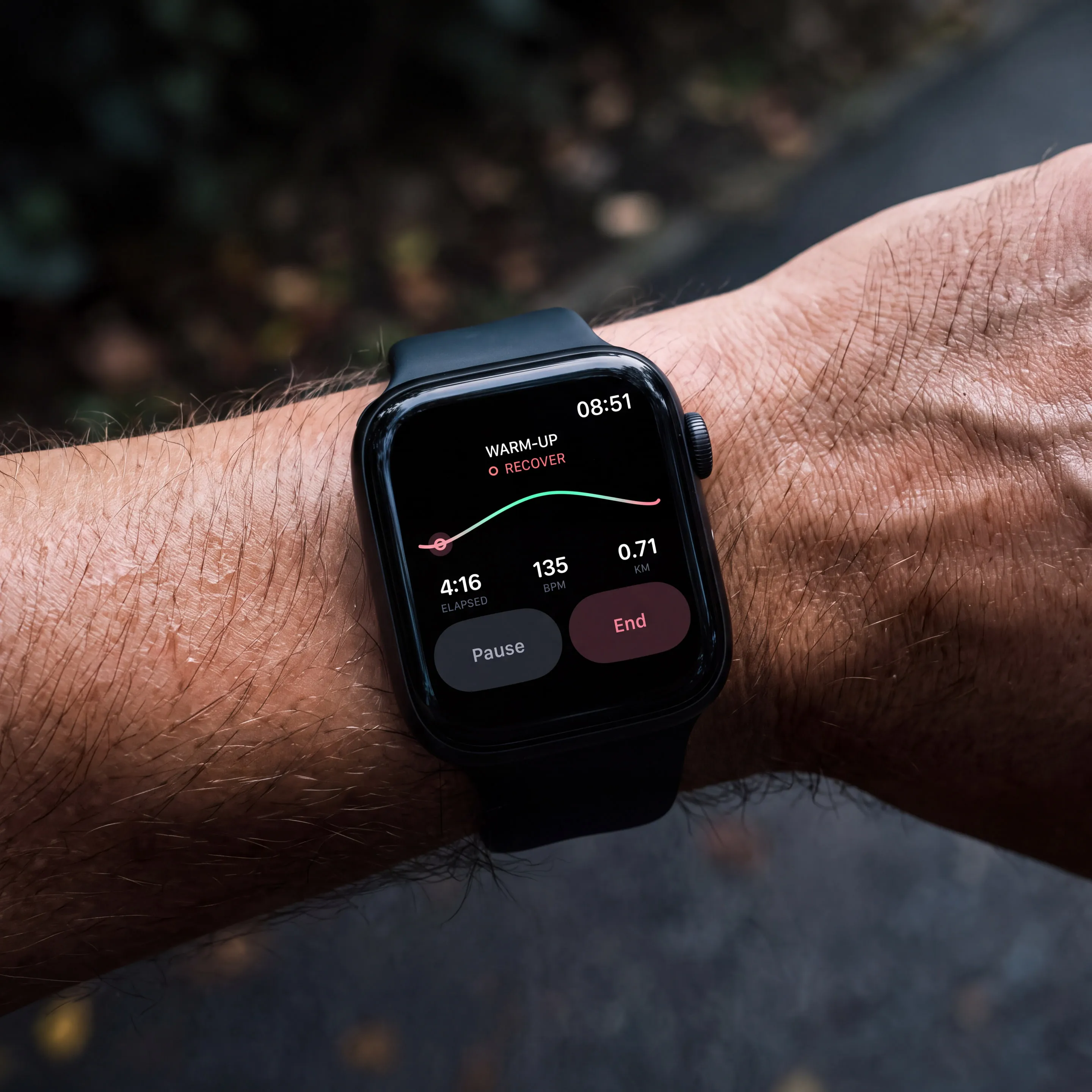 Wrist with the Apsia watch showing the warm-up: recover, in rosé, 135 bpm